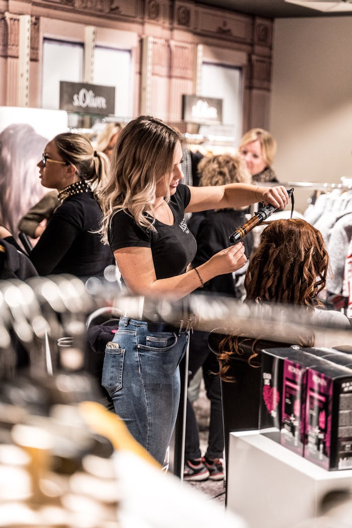 Woman Curling Another Womans Hair